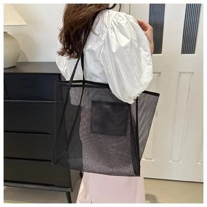 Black mesh tote bag detail showing large capacity and breathable nylon net material