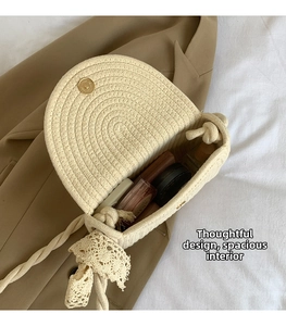 Detail of beige straw bag with lace strap showing interior capacity for makeup