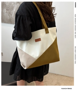 Detail of color-block tote bag with a fashion leather patch and large capacity design