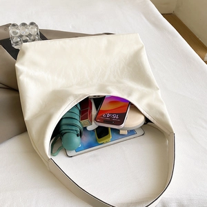 Large cream white faux leather tote bag showing spacious interior with tablet and umbrella