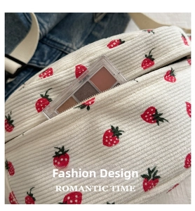 Detail of strawberry print corduroy crossbody bag showing internal storage space