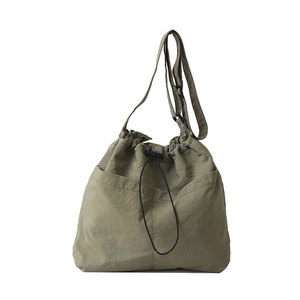 Olive green drawstring nylon crossbody bucket bag with large pockets and adjustable strap