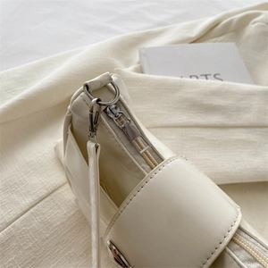 Chic cream bow handbag with silver metal zippers and premium faux leather texture