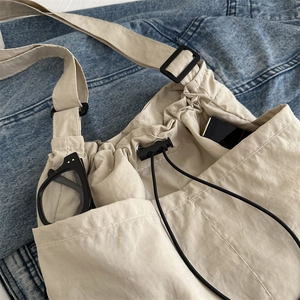 Beige large capacity nylon tote bag with drawstring closure and functional utility pockets