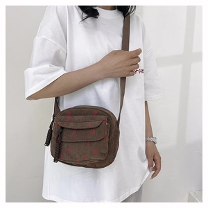 Brown corduroy crossbody bag with red strawberry print and double zipper compartments