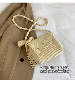 Close-up of beige woven crossbody bag featuring pearl buckle and lace bow accent