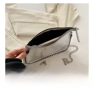 Silver metallic mini bag with bead trim showing interior storage space for a smartphone