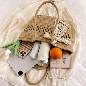 Straw tote bag with colorful dots and lace bows featuring a large capacity interior