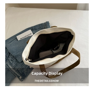Top view of large canvas tote bag showing spacious black interior and zipper closure