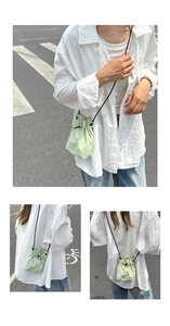 Close-up of light green drawstring crossbody bag in textured nylon material