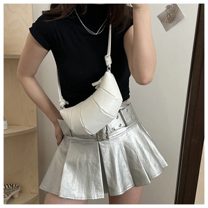 Detail of white pleated croissant crossbody bag with matte finish and slim shoulder strap