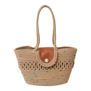 Handmade woven straw tote bag with pearl detail and colorful stitching for summer