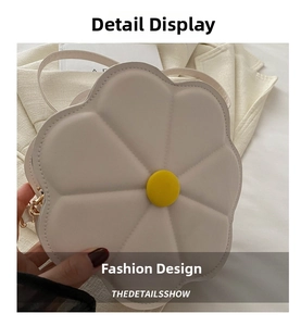 Close-up of a white flower-shaped crossbody bag with quilted petals and yellow center