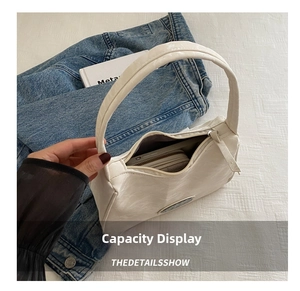 Detail showing white hobo bag interior capacity with long wallet and phone inside
