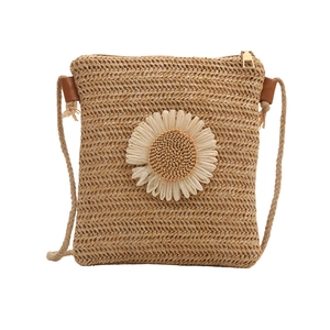 Crossbody woven straw bag with large white daisy flower and golden zipper closure