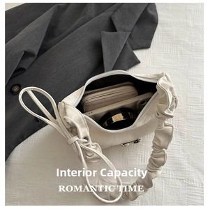 Detailed internal view of the white pleated bag showing room for phone and wallet