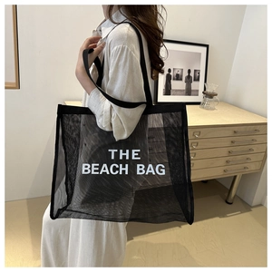 Detail of THE BEACH BAG large black mesh tote with breathable fabric and wide shoulder strap