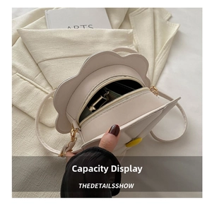 Detailed interior view of a white flower-shaped crossbody bag showing storage capacity