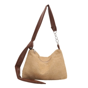 Large woven straw tote bag with brown leather straps and metal chain for summer style