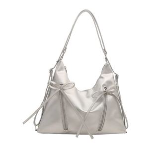 Silver large tote bag with metallic finish featuring bow details and front zippers