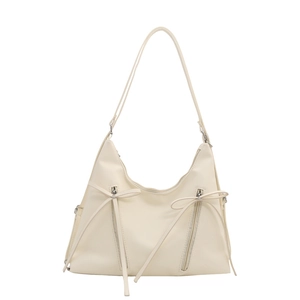 Minimalist beige bow bucket shoulder bag with decorative zippers and long ribbon straps