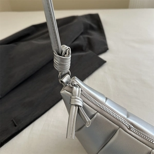 Silver metallic quilted dumpling crossbody bag with stylish knotted shoulder strap detail