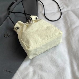 Mini light yellow oxford nylon drawstring crossbody bag for women with black rope strap