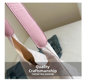 Close-up of pink leather strap and white woven textured fabric on tote shoulder bag