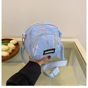 Detail of light blue canvas crossbody bag with wavy embroidery and Fashion logo tag