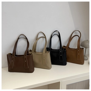 Minimalist faux leather tote bags in four colors with contrast stitching and silver rivets