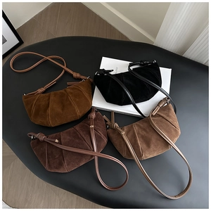 Detailed close-up of matte suede croissant bags in various earth tones with pleats