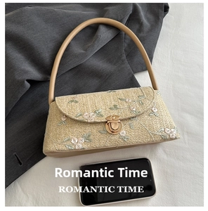 Detailed size comparison of beige woven bag with floral embroidery against a smartphone
