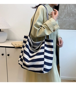 Detail of blue and white striped canvas tote bag showing thick cotton fabric texture