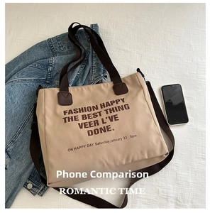 Detail of canvas tote bag showing interior capacity compared to a smartphone