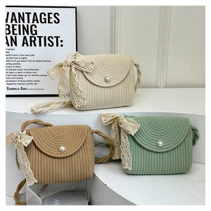 Handwoven straw shoulder bags with pearl buckles and lace bows in natural colors