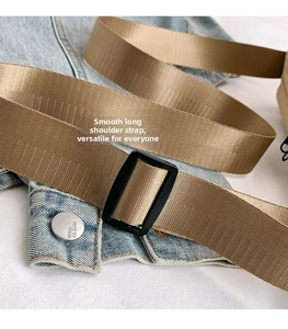 Detailed view of adjustable khaki nylon shoulder strap with black plastic buckle