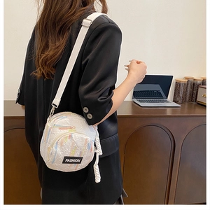 Vertical white crossbody phone bag worn by model over a black blazer in office