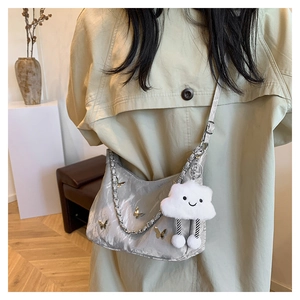 Silver crescent hobo bag with 3D butterfly accents and a plush cloud charm detail
