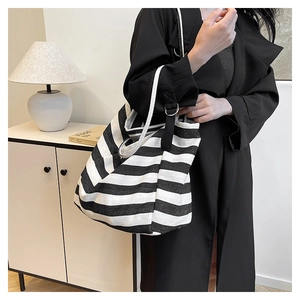 Detail shot of the black and white striped canvas tote bag with thick shoulder strap