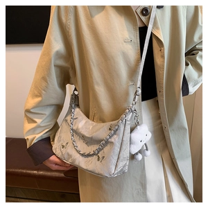 Detail of silver satin tote bag with metallic butterfly accents and white plush cloud charm