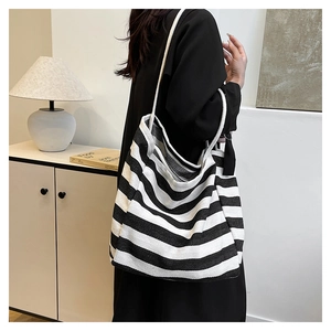 Detail of black and white striped canvas tote with durable thick rope shoulder straps
