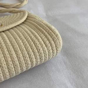 Handwoven straw shoulder bag in cream white with natural fiber texture for summer fashion