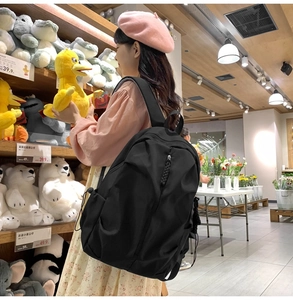 Black waterproof nylon backpack with large main compartment and side pockets for daily use