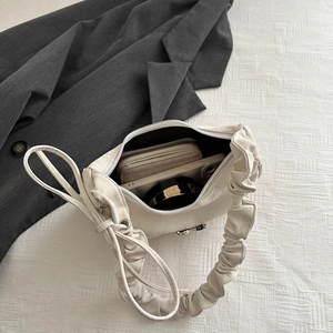 White ruched cloud-style underarm bag showing interior space for wallet and phone