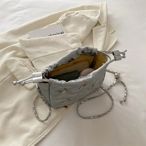 Silver pleated bucket bag with chain strap showing spacious interior with daily items