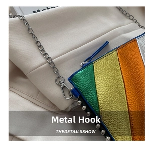Detail of colorful pebbled leather handbag with silver chain and metal hardware hook