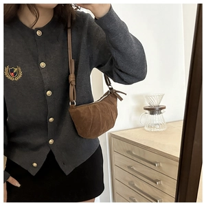 Brown suede half-moon bag shown in a mirror selfie for size and styling reference