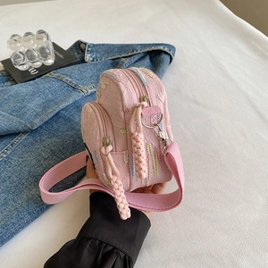 Pink quilted canvas crossbody phone bag with colorful embroidery and woven rope zipper pulls