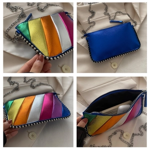 Detailed view of rainbow striped metallic crossbody bag with silver rivet trim and chain