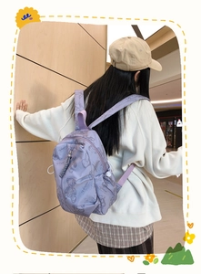Rear view of lavender backpack with bear prints and adjustable side drawstring pockets